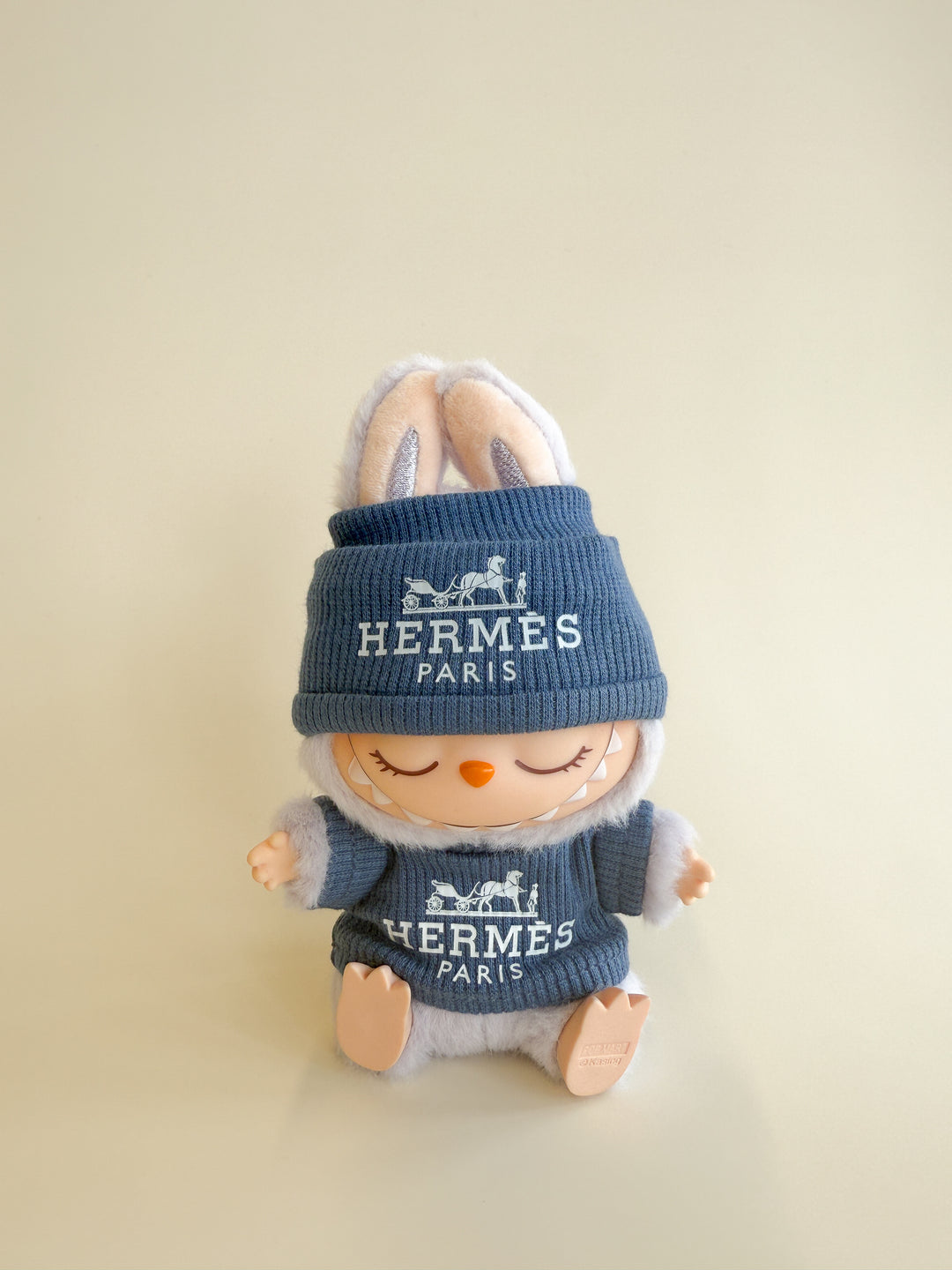 Plush toy wearing a blue 'Hermes Paris' outfit on a beige background
Labubu Hermes Accessories
Labubu Hermes Clothes
Labubu Hermes Fashion
Labubu designer fashion
Labubu Hermes Outfit