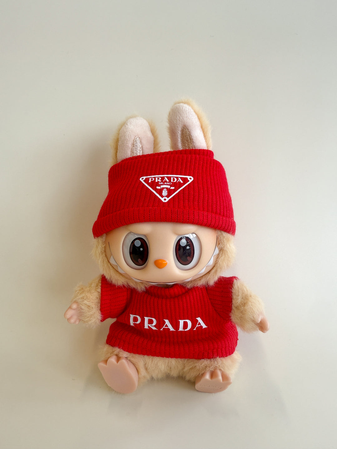 Plush toy with red Prada outfit on a light background
Labubu Prada Accessories
Labubu Prada Clothes
Labubu Prada Fashion
Labubu designer fashion
Labubu Prada Outfit