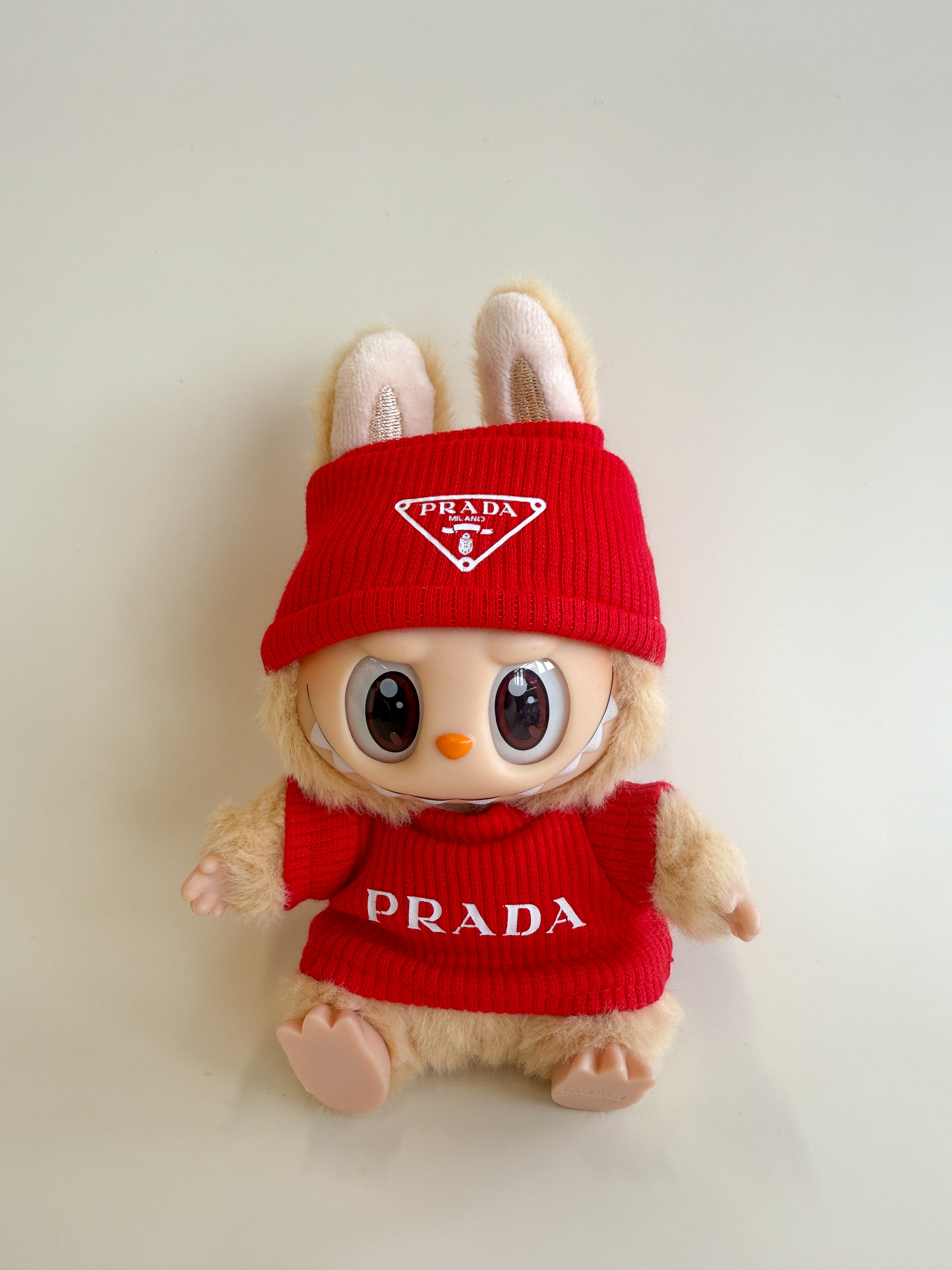 Plush toy with red Prada outfit on a light background
Labubu Prada Accessories
Labubu Prada Clothes
Labubu Prada Fashion
Labubu designer fashion
Labubu Prada Outfit
